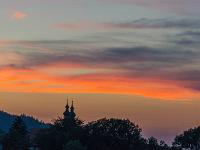 Farbiger Wolkenstreifen über den Kirchtürmen